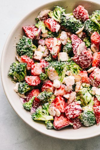 Creamy Broccoli Salad is a delicious broccoli salad with fresh strawberries, almonds, and feta cheese. Strawberries and broccoli combination create a sweet and savory salad with the creamy dressing on top makes it the best! Creamy Strawberry Broccoli Salad in a