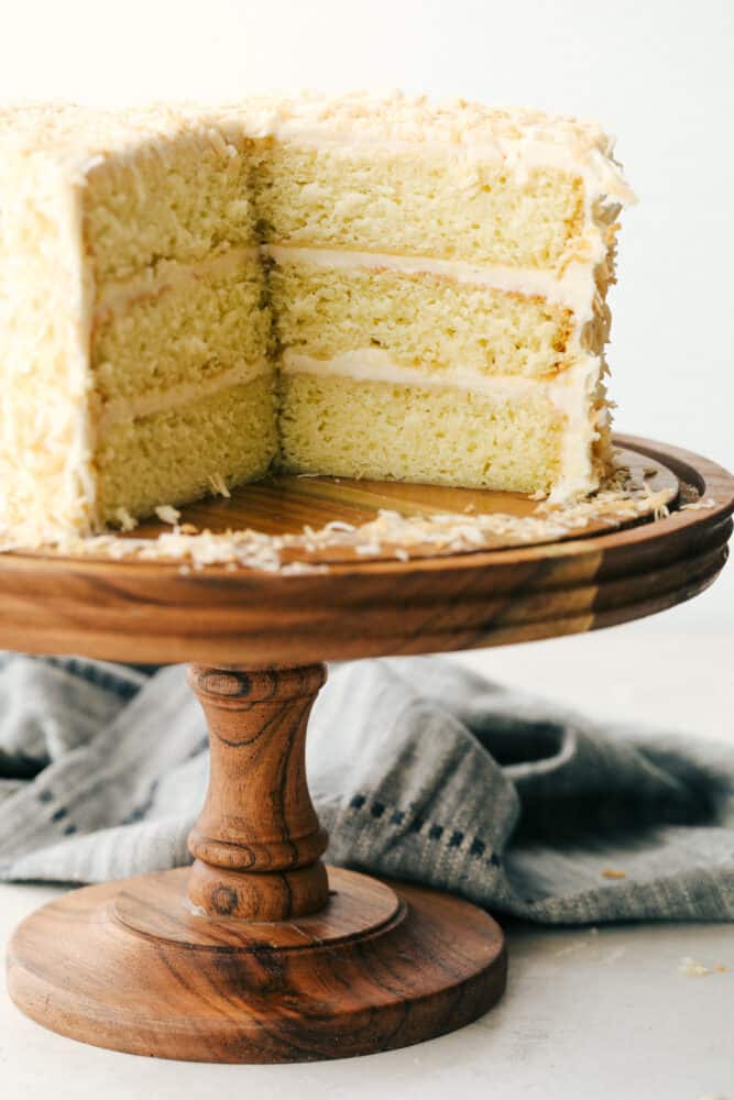 Coconut Cream Cake with Coconut Cream Cheese Frosting is super moist and delicious with the best coconut cream cheese frosting! This cake will be devoured and loved by all! Sliced coconut cake, you can see all the layers.