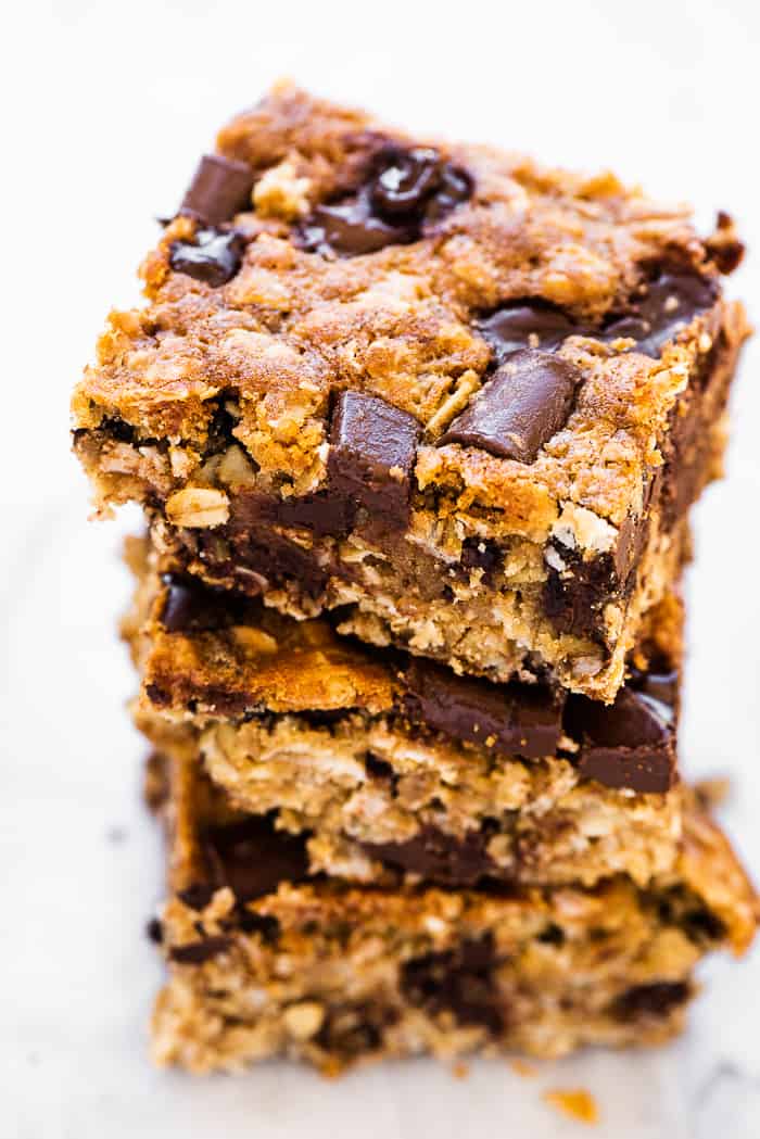 These oatmeal chocolate chip bars are a delicious treat. They're thick and chewy, full of sweet chocolate chips, and perfect for any occasion. Bonus that they're very easy to make! A stack of 3 oatmeal chocolate chip bars.
