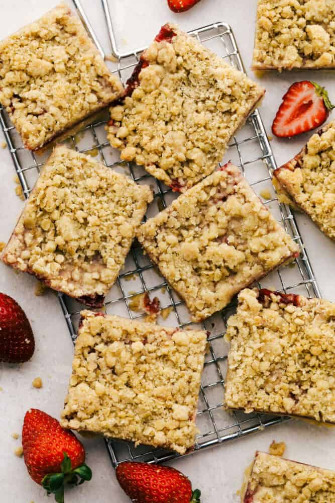 Strawberry Streusel Bars are buttery, sweet and the perfect summertime treat! With a tasty shortbread and mouth watering crumble top, everyone is going to love these! Strawberry streusel bars cut into squares for easy grabbing.