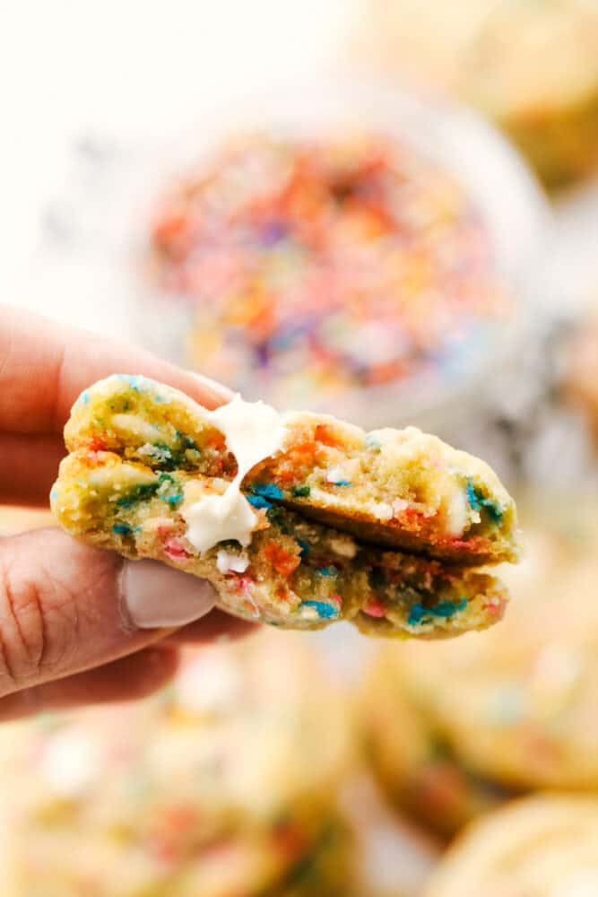 Funfetti Cheesecake Pudding cookies are some of the best tasting and best looking cookies you'll ever have! Made with pudding mix, these are soft, chewy and oh so delicious! Funfetti cookies split in half.