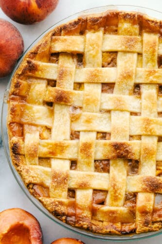 This Homemade Peach Pie is a bit of summer paradise on your plate! Flakey buttery crust is filled with a luscious sweet peach filling that is perfect with a scoop of vanilla ice cream. Baked peach pie.
