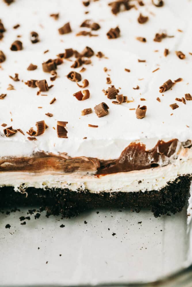 Oreo Lasagna is a no-bake slice of chocolate heaven! Layered with a cream cheese and pudding layer, sandwiched between whipped topping and luscious Oreo crust, it's too die for! Cross cut of the Oreo lasagna showing off the different layers.