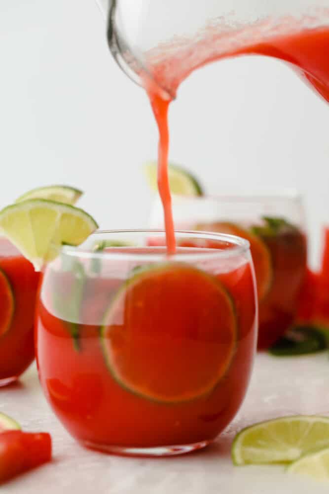 Watermelon Agua Fresca is the perfect drink to keep you cool this summer with the smooth, crisp flavor of fresh watermelon! You are going to love how crazy delicious and easy to make this is! Pouring watermelon agua fresca into glass