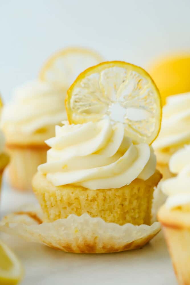 The AMAZING sweet and zesty flavors of these Lemon Cupcakes will have you hooked! Fresh lemon adds a pinch of summer to a classic, decadent treat. Lemon cupcake with lemon garnish