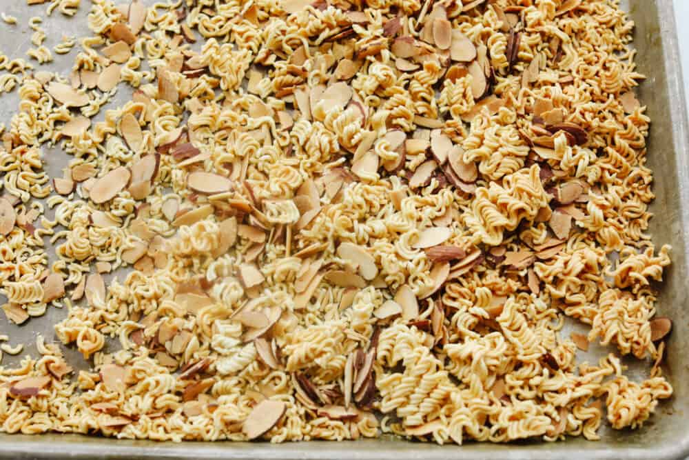 Asian Ramen Salad is full of color, flavor, and crunch! All of the fun textures make it perfectly satisfying and insanely delicious! Toasting the almonds and noodles for crunch and flavor.