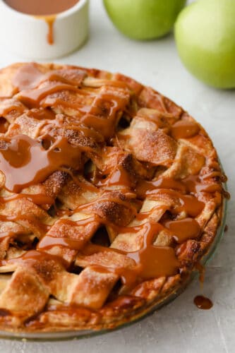 Caramel Apple Pie is the traditional American dessert, but totally elevated. Sour tart apples are smothered in caramel, it's insanely delicious. Caramel apple pie with caramel drizzled on top.