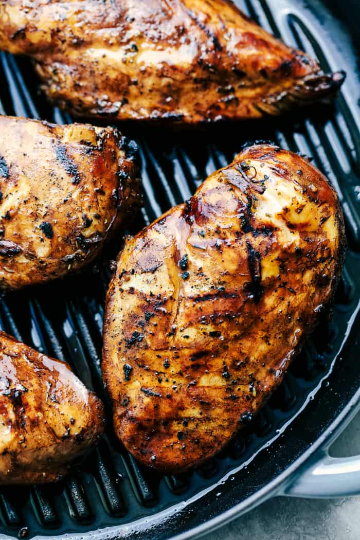 Grilled California Avocado Chicken is tender chicken marinated in an amazing honey garlic balsamic sauce and is grilled to perfection! It is topped with a thick slice of mozzarella cheese and avocados, tomatoes and basil. This chicken is INCREDIBLE!! Chicken on the grill.