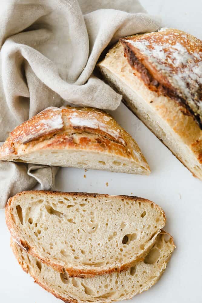 Sourdough Bread is one of the most flavorful, good-for-you loaves of bread out there. Easier than you think with a taste and texture that is absolutely heavenly! Slices of sourdough bread ready to eat.
