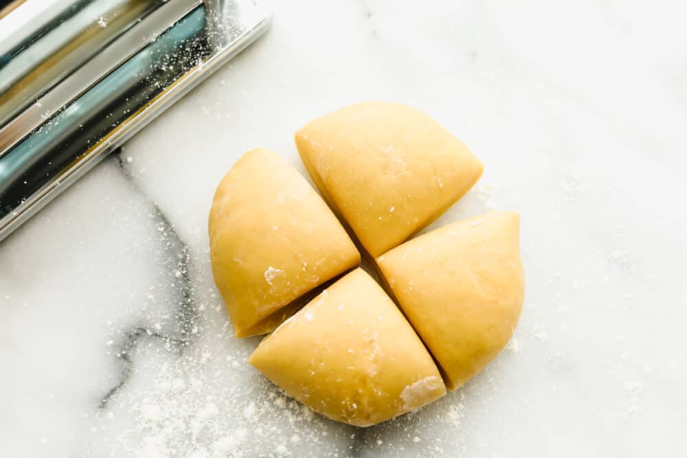 Homemade pasta is a labor of love but it is totally worth the extra work. This pasta is simple and easy, it just takes a bit of time Cutting rested dough into quarters.