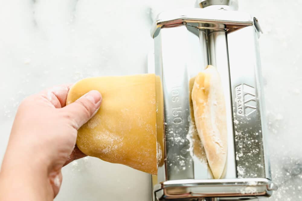 Homemade pasta is a labor of love but it is totally worth the extra work. This pasta is simple and easy, it just takes a bit of time Feeding the dough into a pasta roller.
