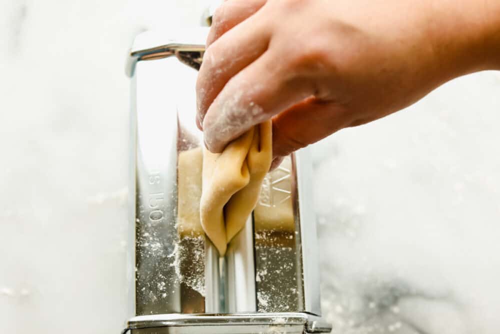Homemade pasta is a labor of love but it is totally worth the extra work. This pasta is simple and easy, it just takes a bit of time Feeding the folded pasta into the pasta maker.