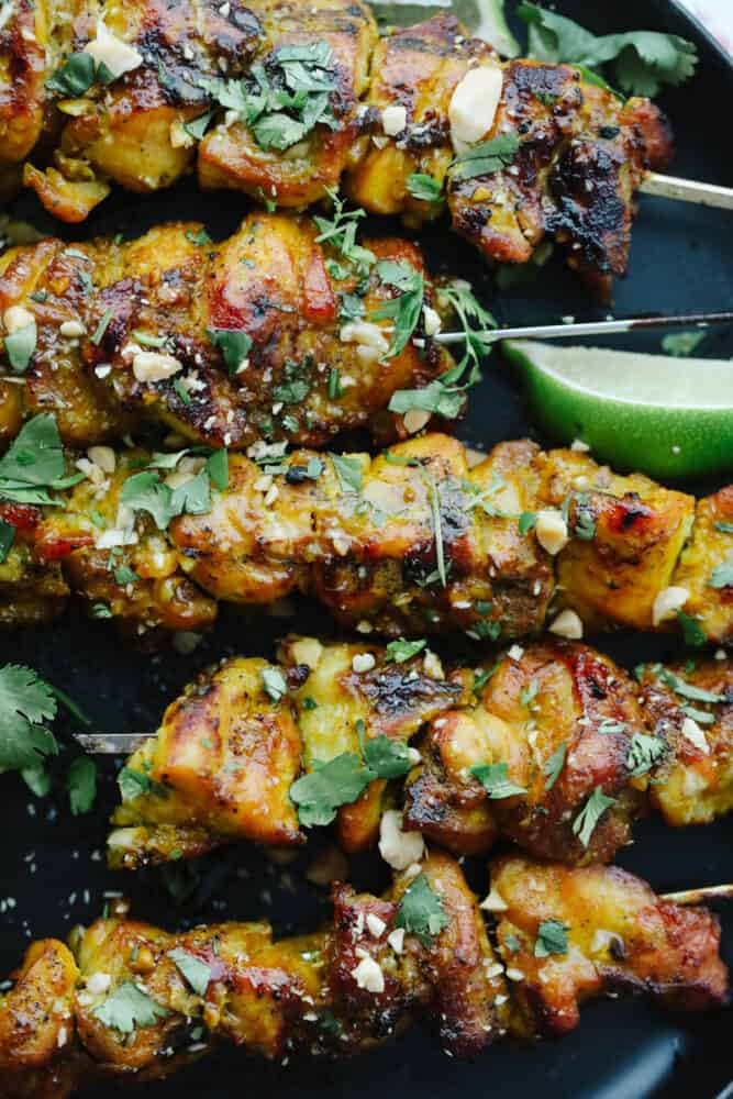 These Thai chicken skewers are marinated in coconut milk, curry, and spices and then grilled to perfection. It's a quick and easy meal that's packed full of flavor! Upclose picture of thai chicken.