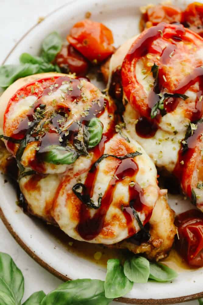 Baked Caprese chicken is nothing less than delicious and delightful! It's fancy enough for company but simple enough for a quick and easy weeknight dinner that your family will go crazy for! Close up of baked Caprese chicken.