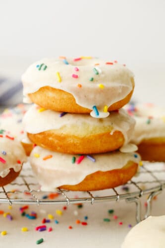 Cake donuts are rich and golden and take the word delicious to the next level!! The sweet taste completely melts in your mouth and the delicate frosting with sprinkles will leave you asking for more! Stack of donuts.