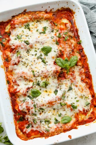 This manicotti is filled with 3 kinds of cheese and baked to absolute perfection! It's comfort food at its finest that everyone will go crazy over! It's definitely sure to please a large crowd! Cooked manicotti in a casserole dish.