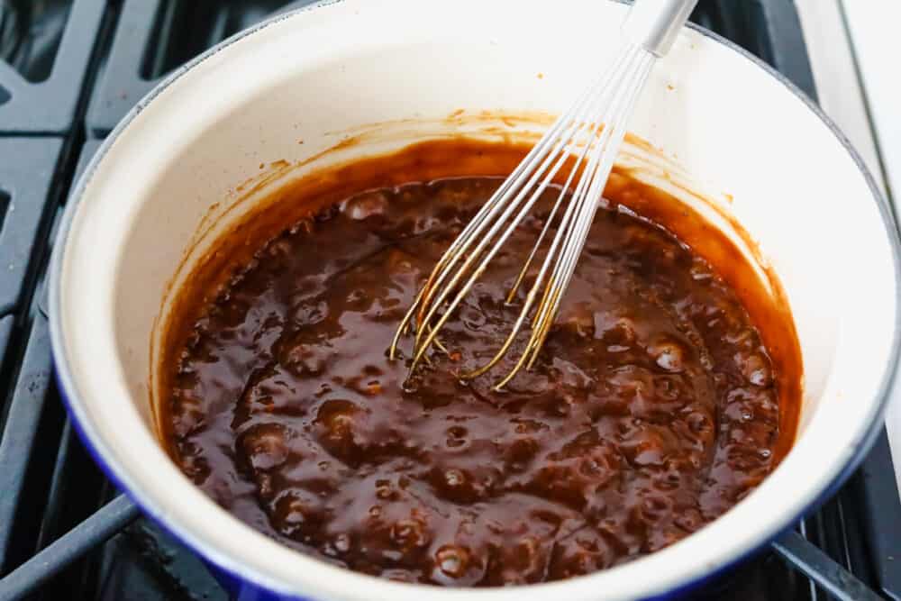Rich, sweet, and salty, hoisin sauce is the perfect foundation for all of your Asian-inspired dishes. This homemade variation packs so much delicious flavor, you won't want store-bought again! Whisking sauce ingredients together on the stove.
