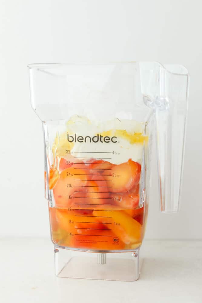 This peach smoothie is juicy and refreshing and provides a burst of delicious flavor! The texture is just perfect, the color is beautiful and the taste is something everyone in your family will go crazy for! Smoothie ingredients in a blender.