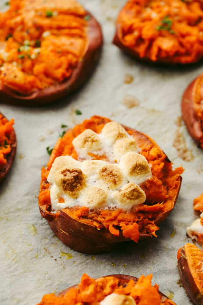 Smashed sweet potatoes are crispy on the outside and soft and smooth on the inside! They can be cooked to taste sweet OR savory and they both have a mouthwatering taste that is divine! You will love every single bite! Close up of a sweet smashed sweet potato.