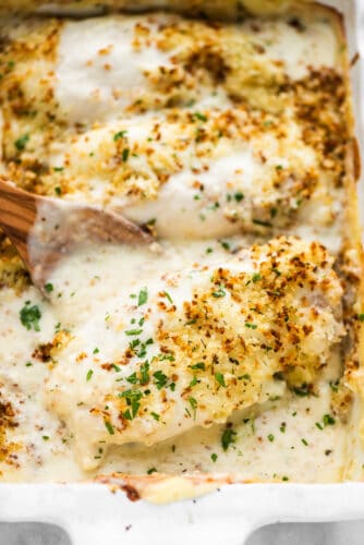 Creamy Swiss Chicken Bake is absolutely delicious. Chicken breasts are smothered in an easy-to-make Swiss cheese sauce, covered in crispy, seasoned breadcrumbs, then baked until bubbly. It's an easy chicken casserole the whole family will love! Swiss chicken baked in a casserole dish.