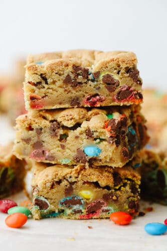 M&M cookie bars are everything you love about blondies and candy in one! Golden, buttery, and ready to feed a crowd, this is the dessert recipe your family will not be able to get enough of! A stack of 3 M&M bars.