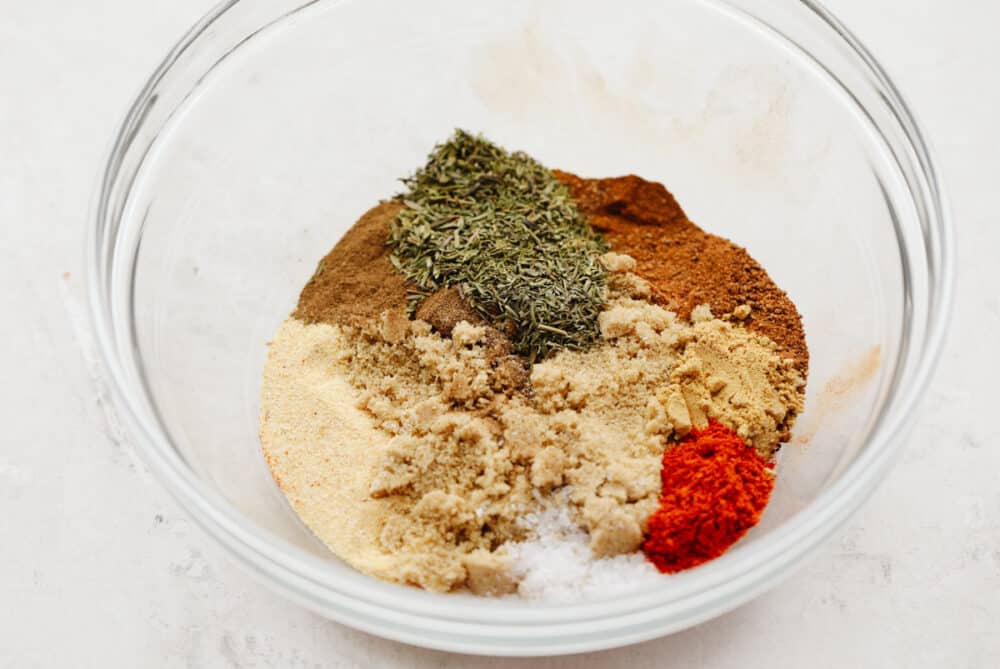Jerk seasoning is the most deliciously sweet and savory blend of spices! It's simple to use and even more easy to make! You will have yourself a custom homemade seasoning in less than 5 minutes! A bowl showing an array of spices ready to be mixed.