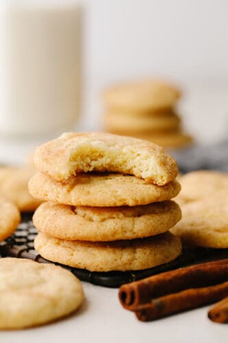 These snickerdoodle are delightfully soft and full of delicious cinnamon flavor! They are SOO GOOD and you won't be able to stop at just one! A stack of snickerdoodle cookies with a bite taken out of the top one!