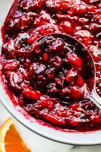 This cranberry sauce is the perfect mixture of sweet and tart! It's made with fresh cranberries and topped with orange zest to really set it apart! Cranberries in a saucepan.