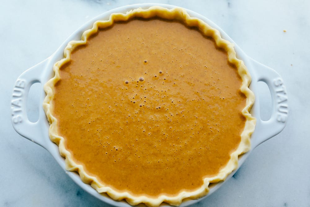Grandma's famous pumpkin pie is smooth, thick, and creamy! A MUST for the holidays and the best when served with a big scoop of whipped cream on top! A pumpkin pie ready to bake
