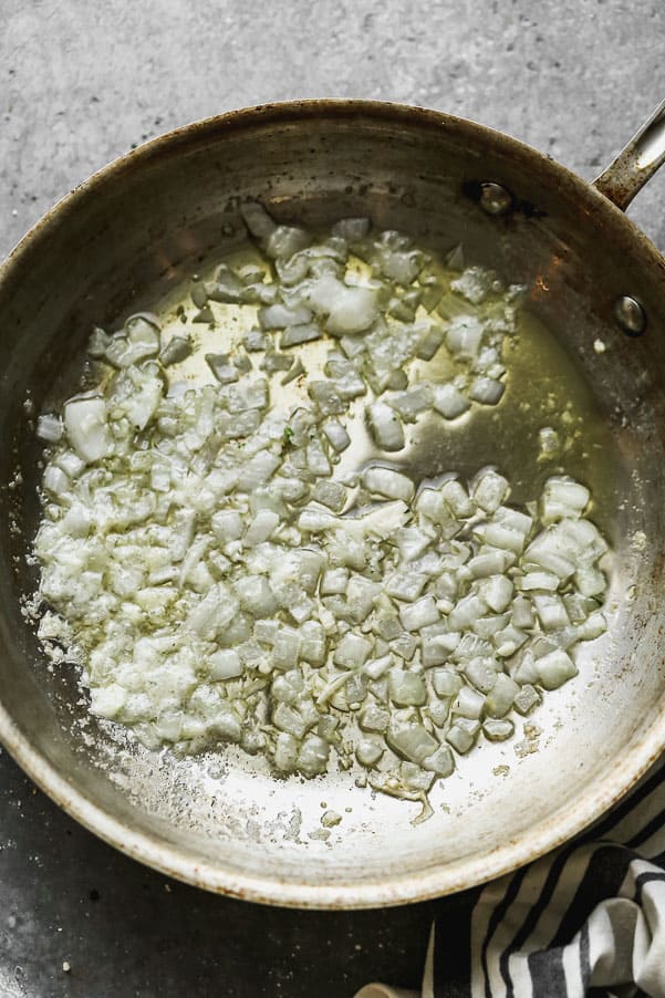 Corn Pudding is one of our favorite fall sides to serve alongside a roast chicken, hearty stew, or of course, turkey! Our version is ultra creamy, slightly sweet, with a hint of savory and packed with while corn kernels. Sautéing onions in butter.
