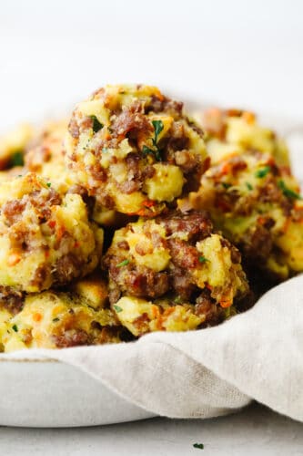 Sausage stuffing balls are the perfect appetizer or side dish for any holiday meal! These are full of such delicious flavors, you won't be able to stop at just one! Sausage stuffing balls in a dish ready to serve.