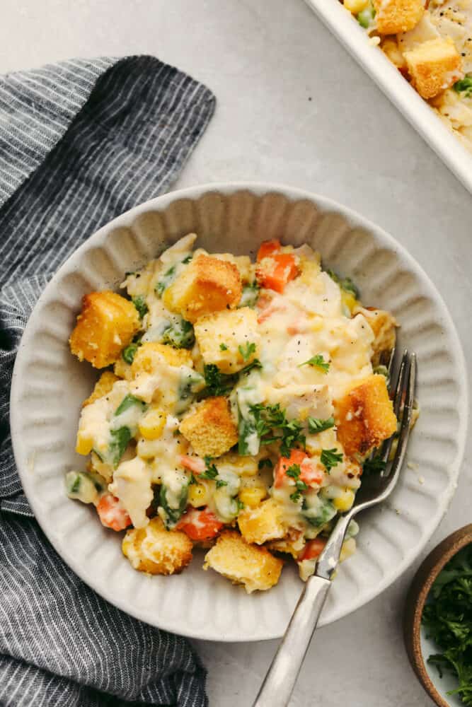 This leftover turkey casserole is creamy and delicious! Made with your leftover turkey, it's the easiest recipe to make just after Thanksgiving! It's SOO GOOD! Turkey casserole in a bowl with a fork on the side.