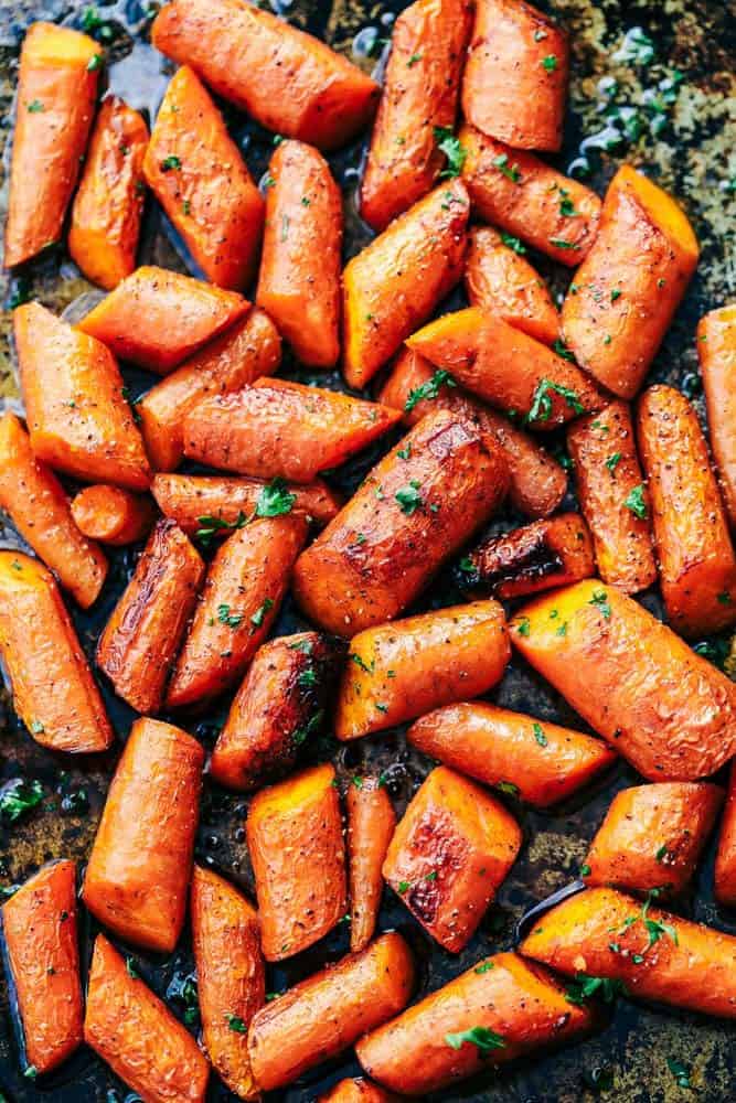 Roasted Brown Butter Honey Garlic Carrots make an excellent side dish. Roasted to tender perfection in the most incredible brown butter honey garlic sauce these will become a new favorite! Roasted carrots spread out on a trayl