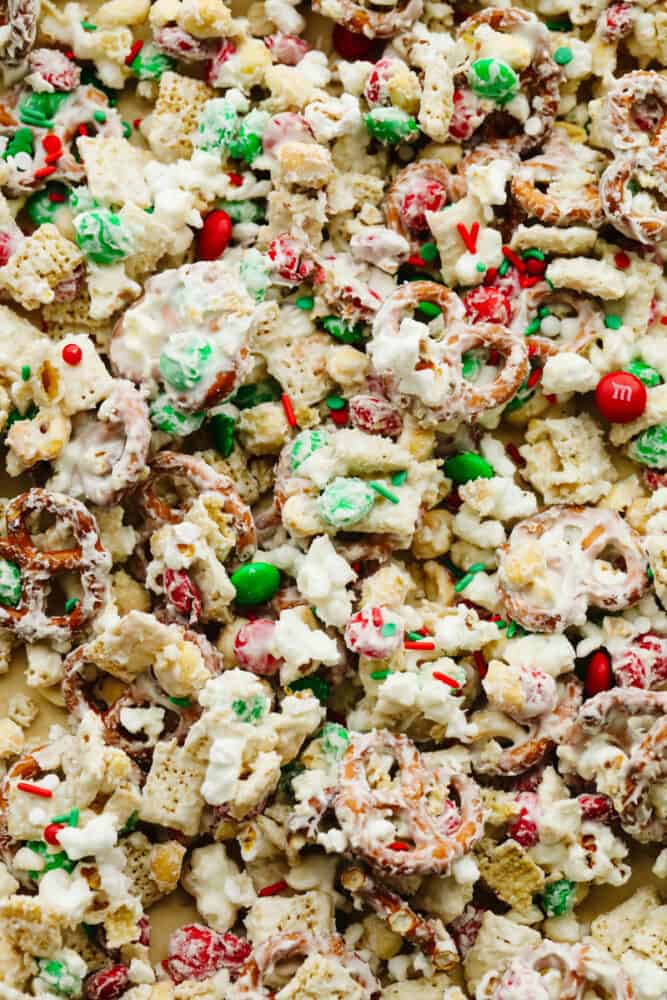 This reindeer food is the most addicting mixture of treats! It's the perfect combo of sweet and salty and ideal for any holiday gathering! Reindeer food spread out on a baking sheet.