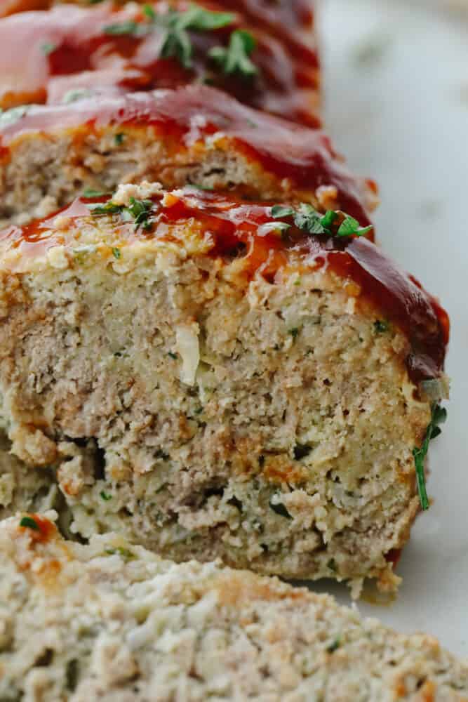 This tasty turkey meatloaf is light and lean but filled with so much flavor! Each bite is perfectly seasoned and tender, you'll love it! Closeup of a meatloaf slice.