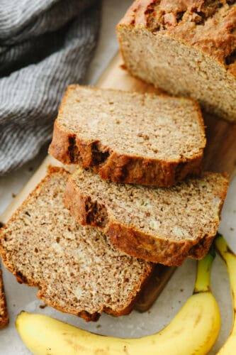 This healthy banana bread is made with NO sugar and it tastes absolutely divine! After you bake up this delicious bread the serve yourself up a slice or two, It's SOO GOOD. Healthy banana bread sliced up.