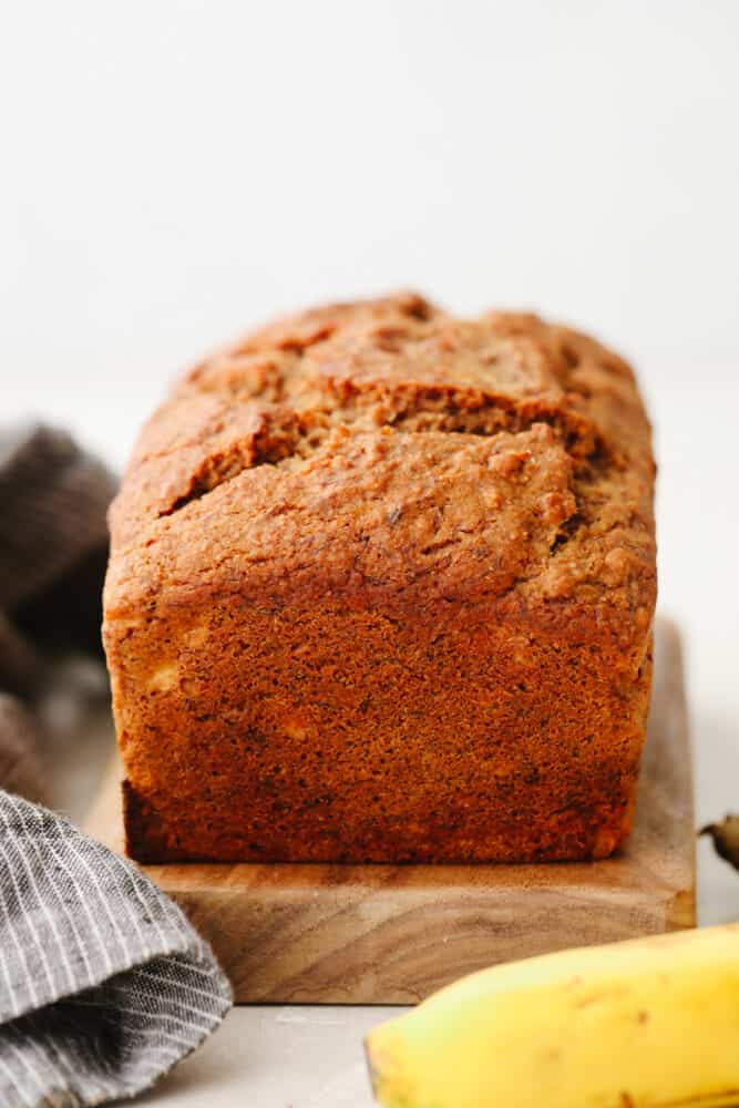This healthy banana bread is made with NO sugar and it tastes absolutely divine! After you bake up this delicious bread the serve yourself up a slice or two, It's SOO GOOD. A loaf of healthy banana bread.