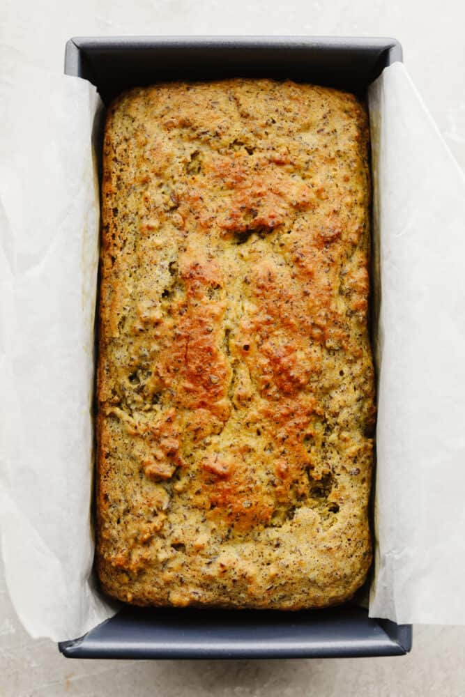 This keto bread is simple and full of delicious flavor! The ingredients are super healthy but that doesn't take away from its amazingly moist texture and taste! Keto bread cooked in a bread pan with parchment paper.