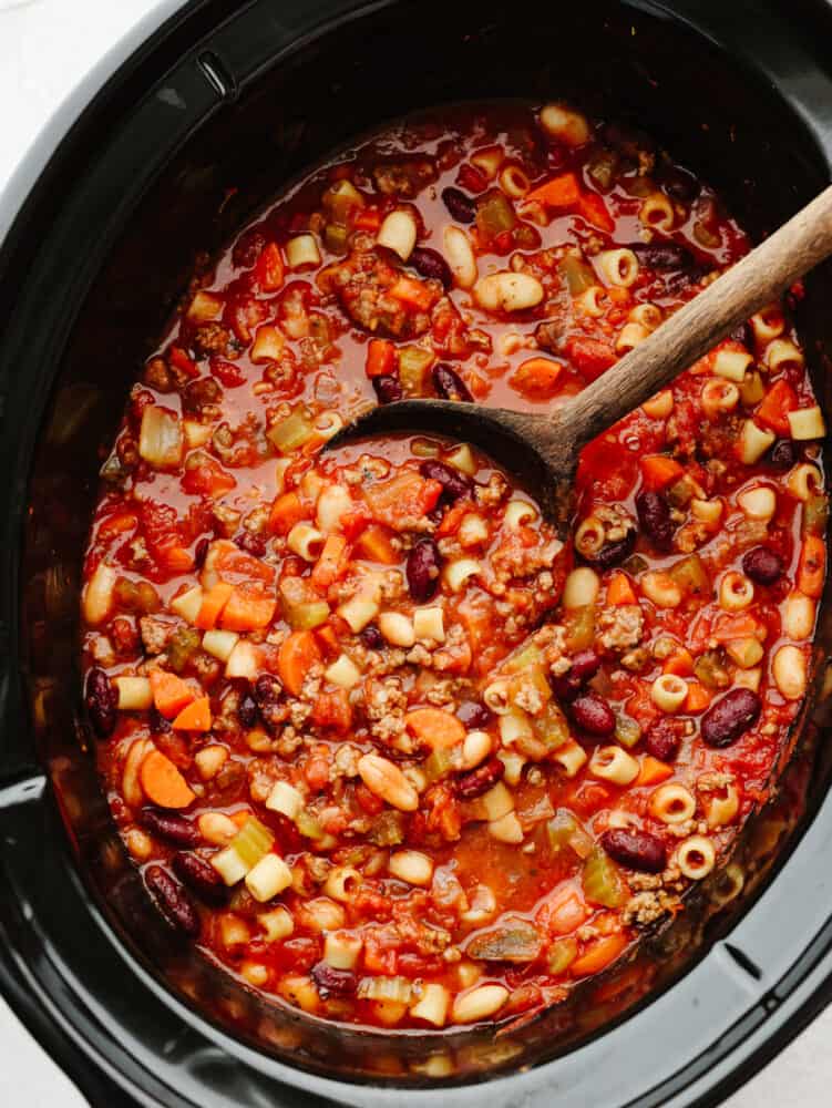 Slow cooker Pasta e Fagioli soup is a rich and hearty Italian soup loaded with pasta, vegetables, beans, and lean ground beef. It's hearty, comforting, and oh so delicious! A slow cooker filled with pasta e fagioli all cooked.