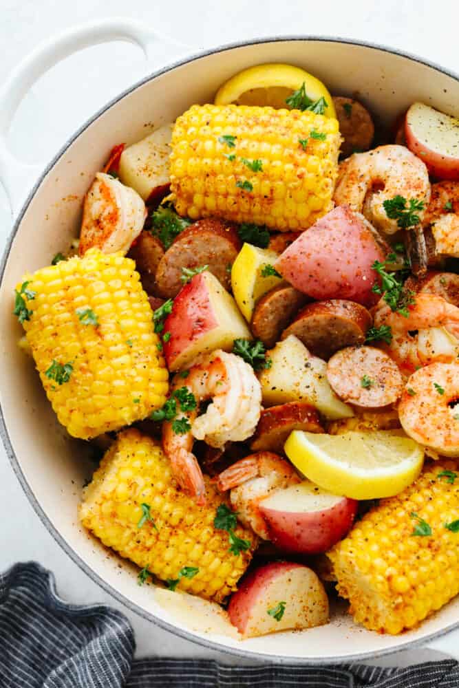 A southern classic, this shrimp boil recipe includes corn, potatoes, sausage, and shrimp boiled together in one pot and packed full of delicious flavor! It's a tried and true favorite that you don't want to miss! Shrimp boil ingredients in a pot.
