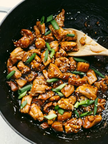 This teriyaki chicken will be the best that you ever make! The tender, juicy chicken is coated with the most amazingly flavored sauce. Once you eat this, it will become your new favorite! A pan of teriyaki chicken being stirred with a wooden spoon.
