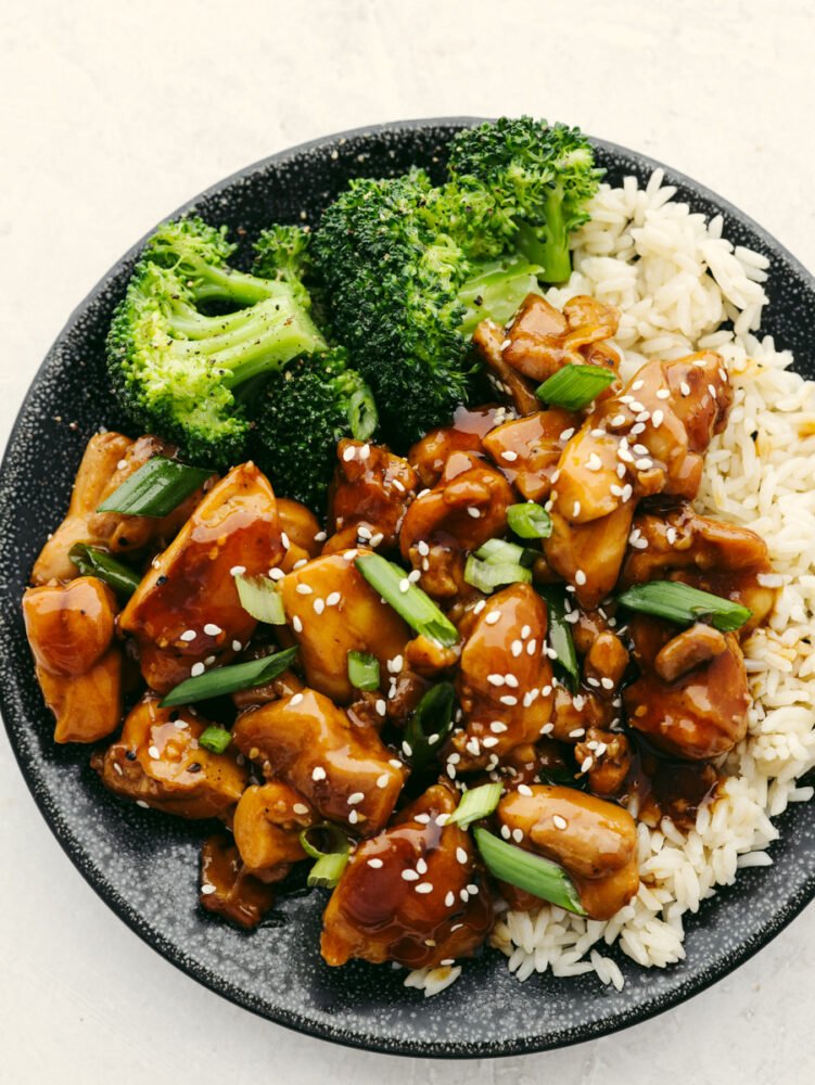 This teriyaki chicken will be the best that you ever make! The tender, juicy chicken is coated with the most amazingly flavored sauce. Once you eat this, it will become your new favorite! A bowl of rice topped with broccoli and teriyaki chicken.