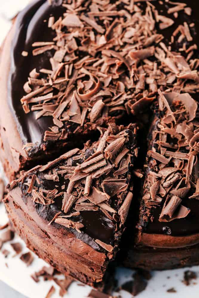 Death by chocolate cheesecake has an Oreo crust with creamy, decadent, and rich chocolate cheesecake. Topped with chocolate ganache, this is a chocolate lover's dream come true! A slice of Death by Chocolate Cheesecake.