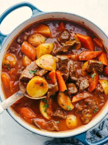 Your family is going to love this hearty Guinness beef stew! This traditional Irish meal is filled with rich, meaty flavor, tender vegetables, and melt-in-your-mouth beef! Guinness stew in a blue skillet.