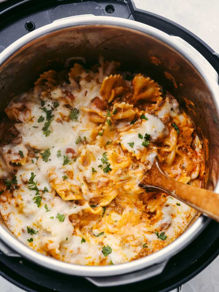 This Instant Pot recipe is filled with all the lasagna flavors you love! Layers of creamy ricotta, melty mozzarella, and ground beef seasoned with Italian herbs come together in this super easy dish! Cooked lasagna casserole in an Instant Pot.