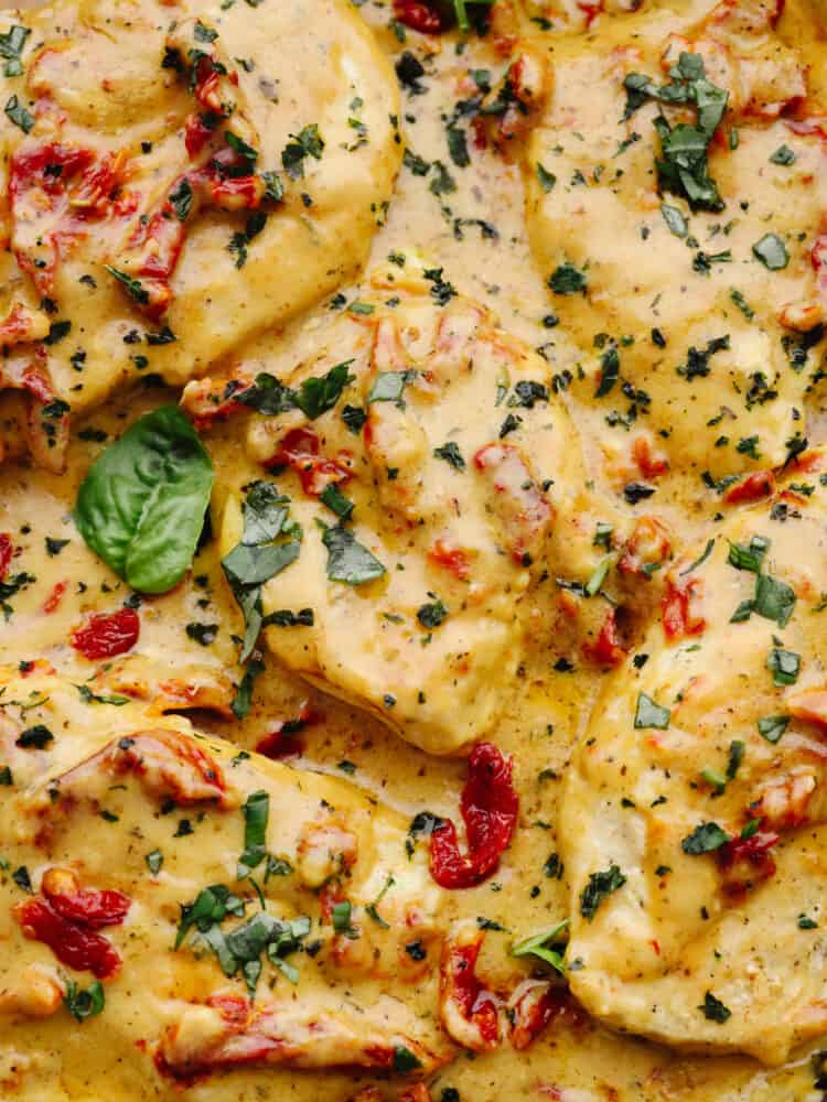 Marry me chicken is juicy and flavorful and smothered in a creamy parmesan sauce. Seasoned with savory herbs and sun-dried tomatoes, this dish will melt in your mouth, and will leave you begging for a proposal! A close up of marry me chicken.
