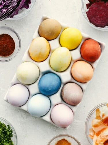 These naturally dyed Easter eggs are such a fun activity for the family! It's amazing to see what colors you can create with basic vegetables and spices! Top-down view of 12 dyed Easter eggs in a carton.