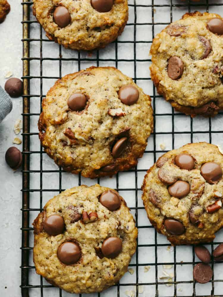 Banana oatmeal cookies with chocolate chips are the ultimate soft and nutty dessert. They're everything you love about banana bread and oatmeal cookies combined in one super easy treat! Closeup of banana oatmeal cookies on a cooling rack.