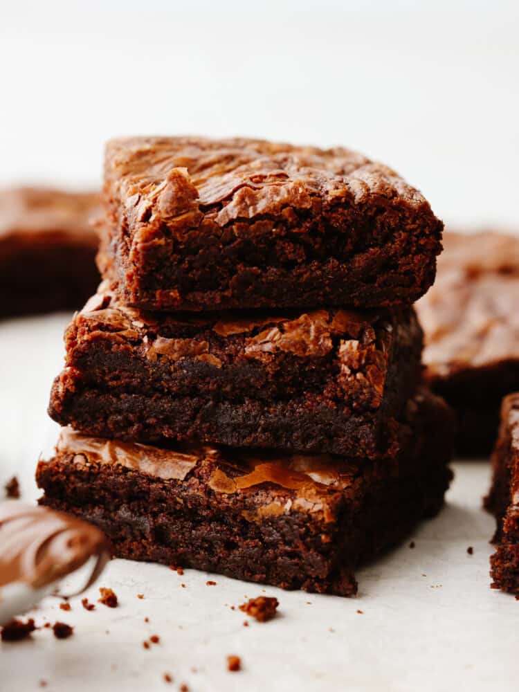 This super easy 3-ingredient brownie recipe is the only one you'll ever need! These brownies are rich and fudgy, the perfect solution for when you're craving chocolate! 3 brownies stacked on top of each other.