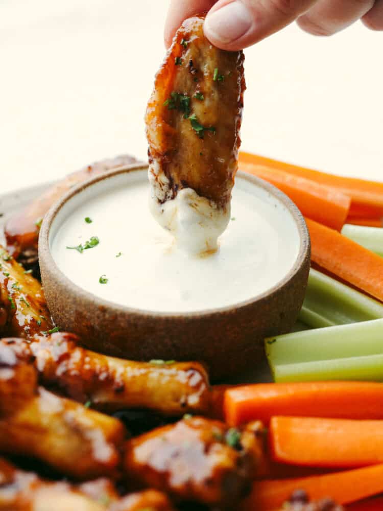 Making your frozen chicken wings in the air fryer is the only method to use, no thawing required! Along with this easy-to-make honey buffalo sauce, you'll never want them any other way! Dipping a chicken wing in a creamy sauce.